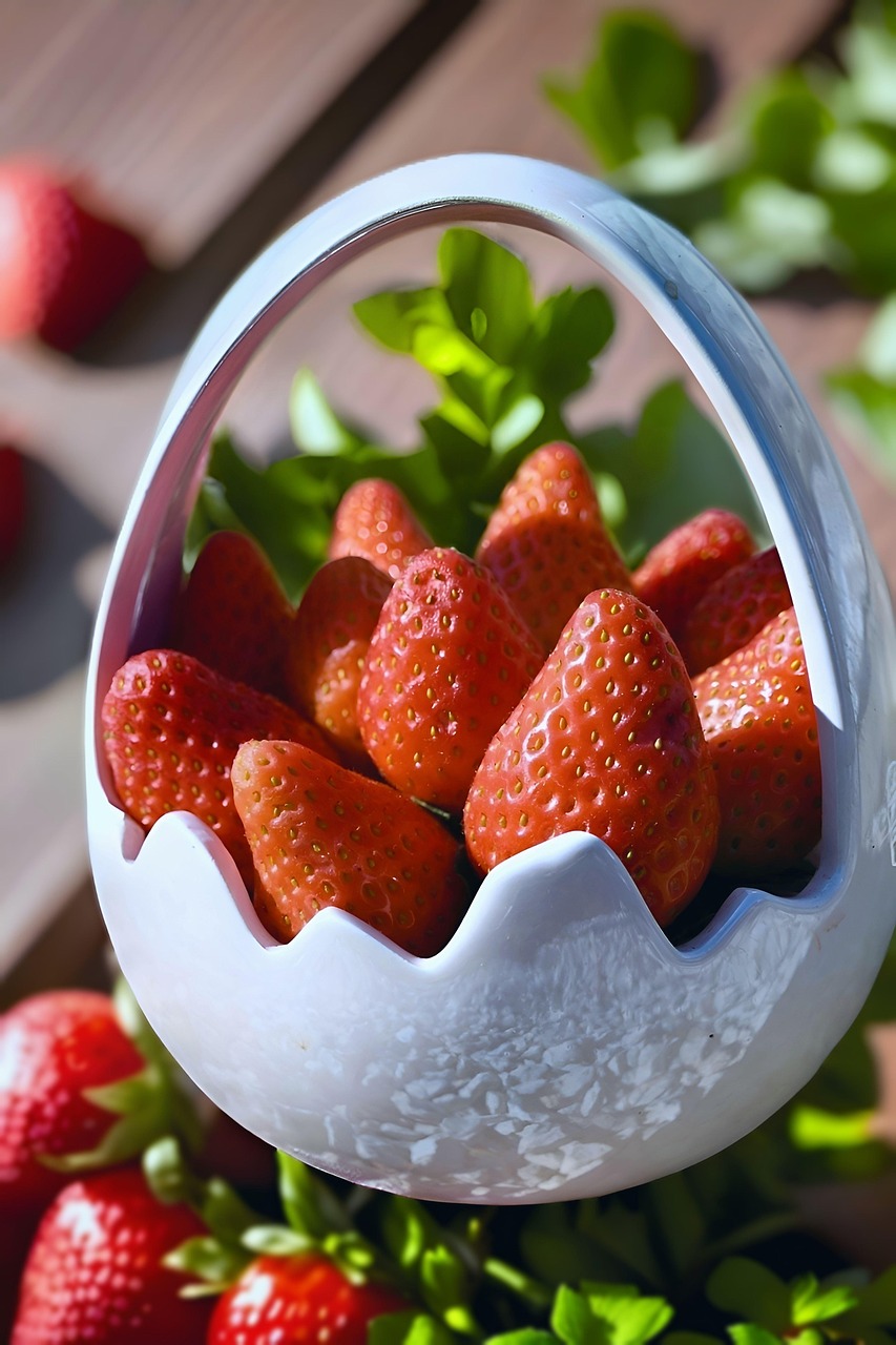 strawberries, fresh fruit, red berries, fruit basket, egg basket, ceramic decor, spring food, healthy eating, natural background, green leaves, still life, food styling, juicy fruit, outdoor food, healthy snack, organic produce, ripe strawberries, easter basket, seasonal fruit, rustic table, garden food, vitamin c, nature photography, berry collection, fruit closeup